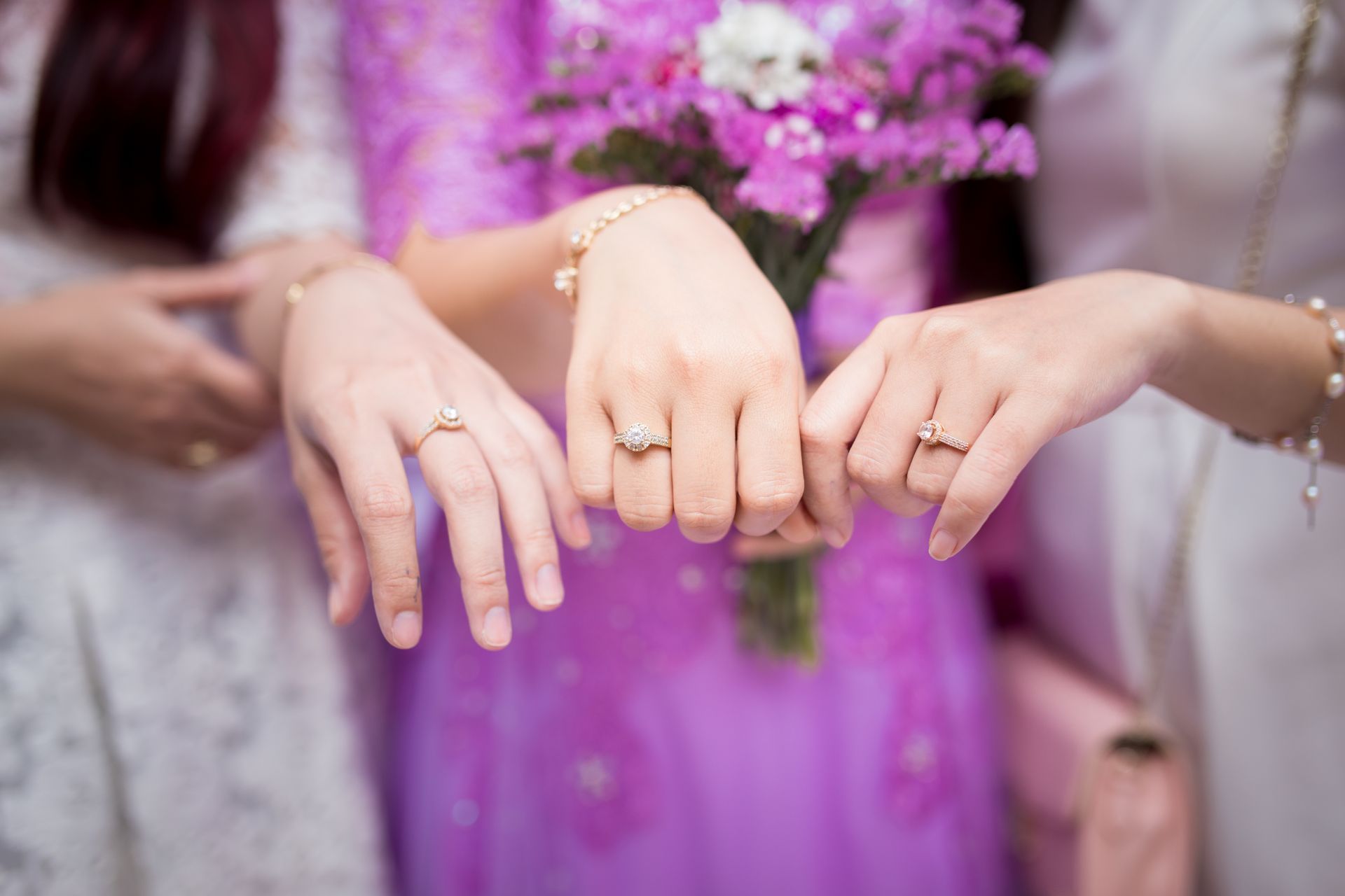 A group of women are posing for a picture with their rings on their fingers.