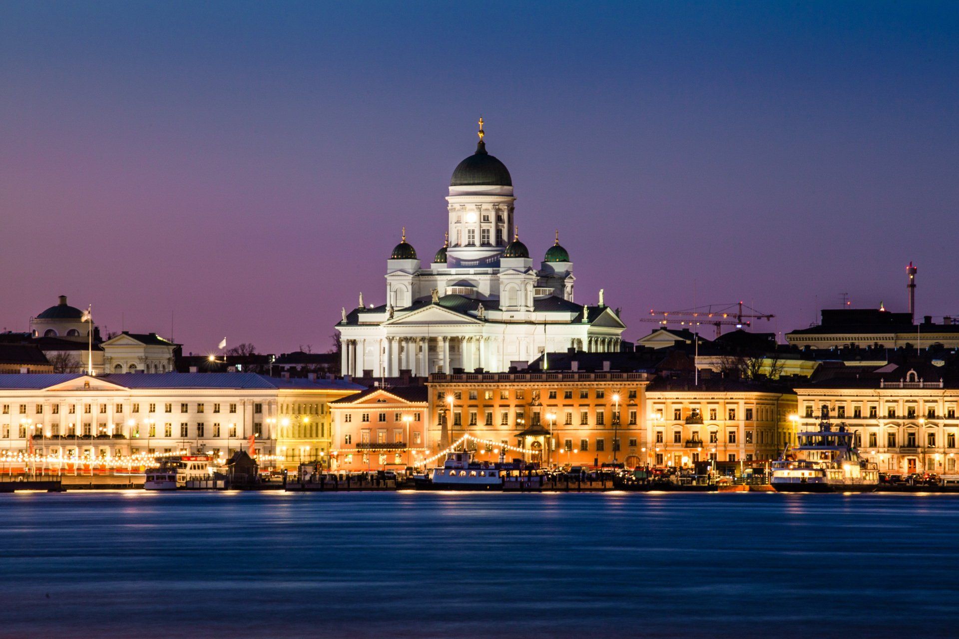 The stunning cityscape of Helsinki at night, with its iconic landmarks and vibrant lights creating a mesmerising view.