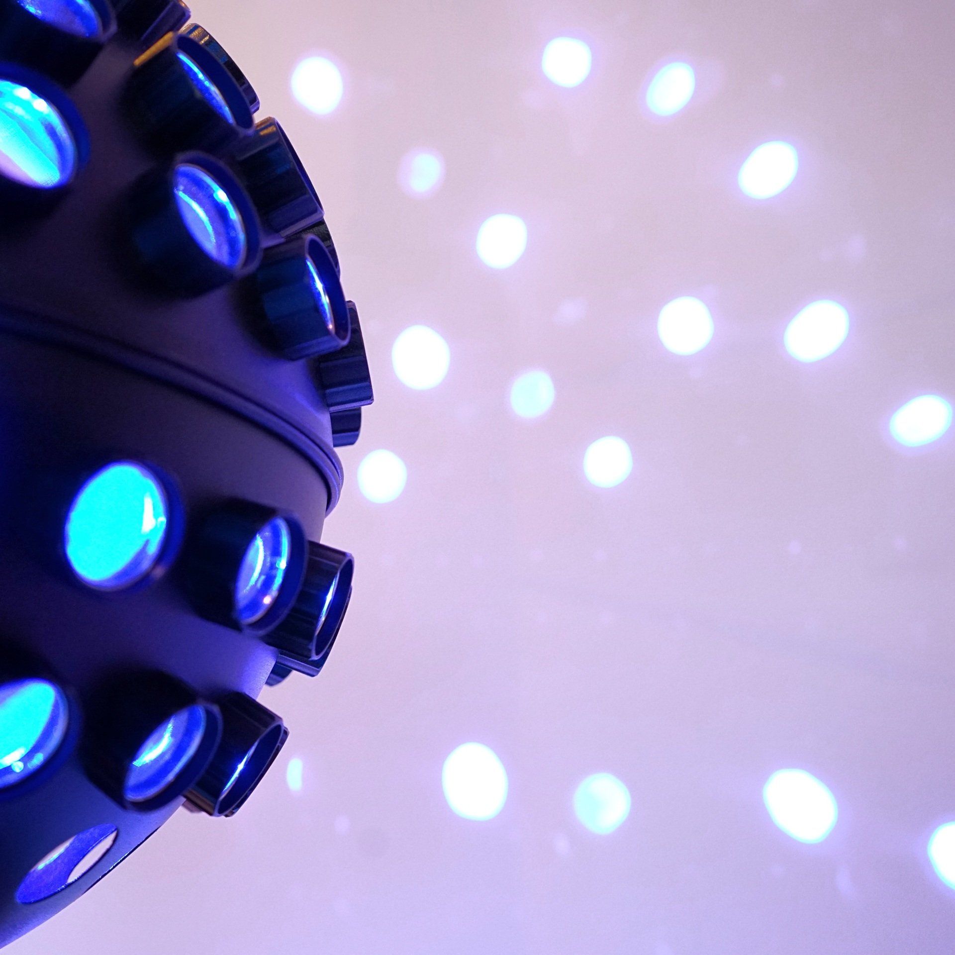 A disco ball with blue lights coming out of it