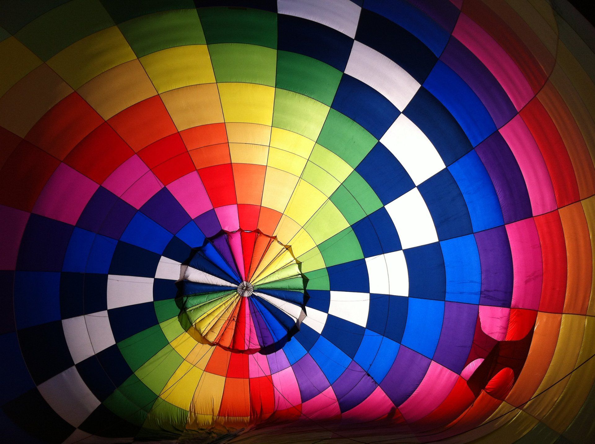 The inside of a colourful hot-air balloon with a chequered pattern