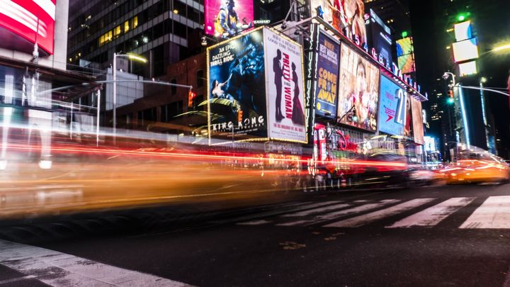 A blurry picture of a city street at night.