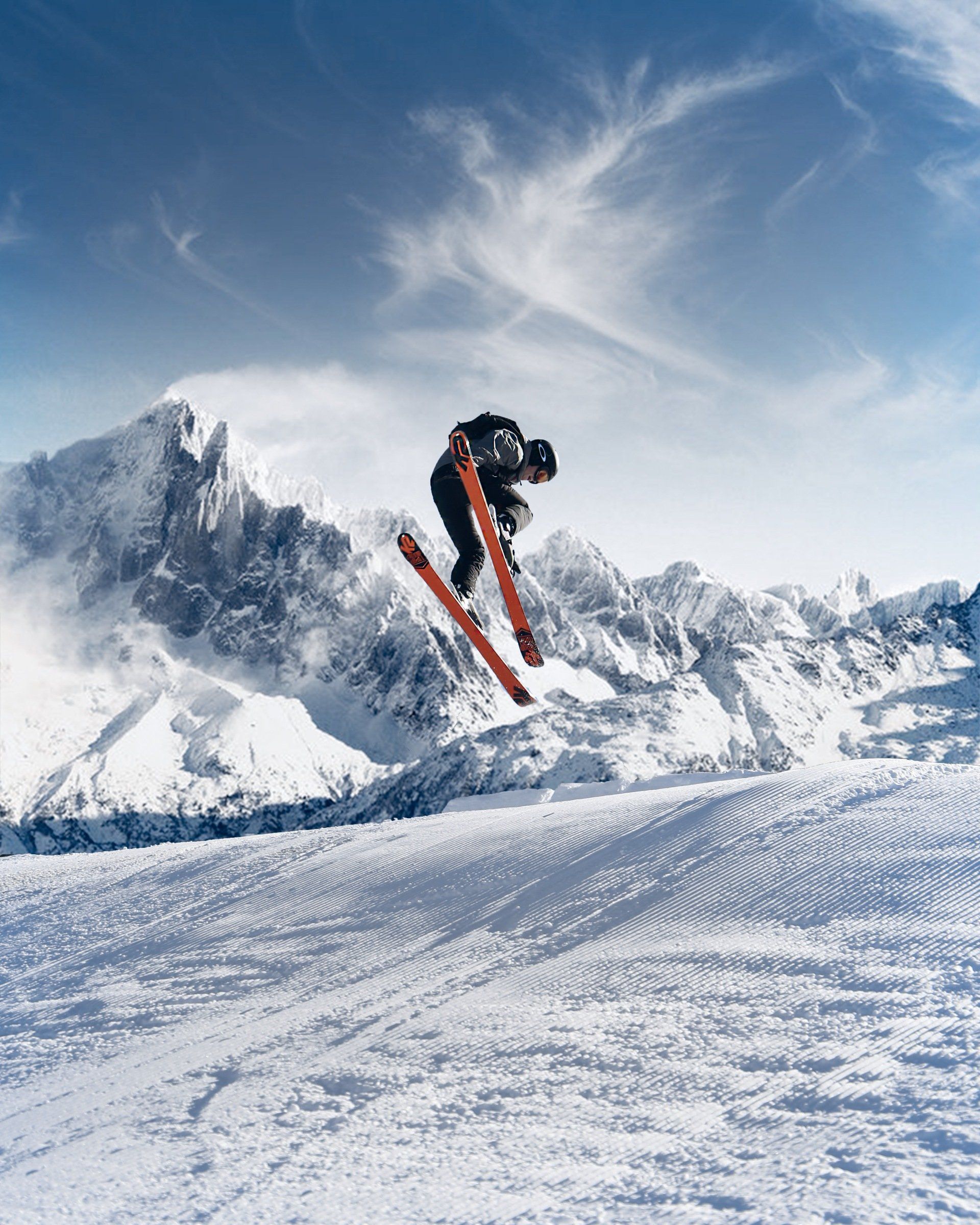 A person is jumping in the air while skiing in the snow