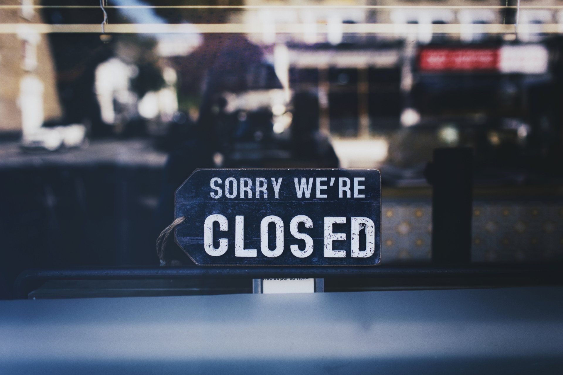 A sign that says `` sorry we 're closed '' is in a window.