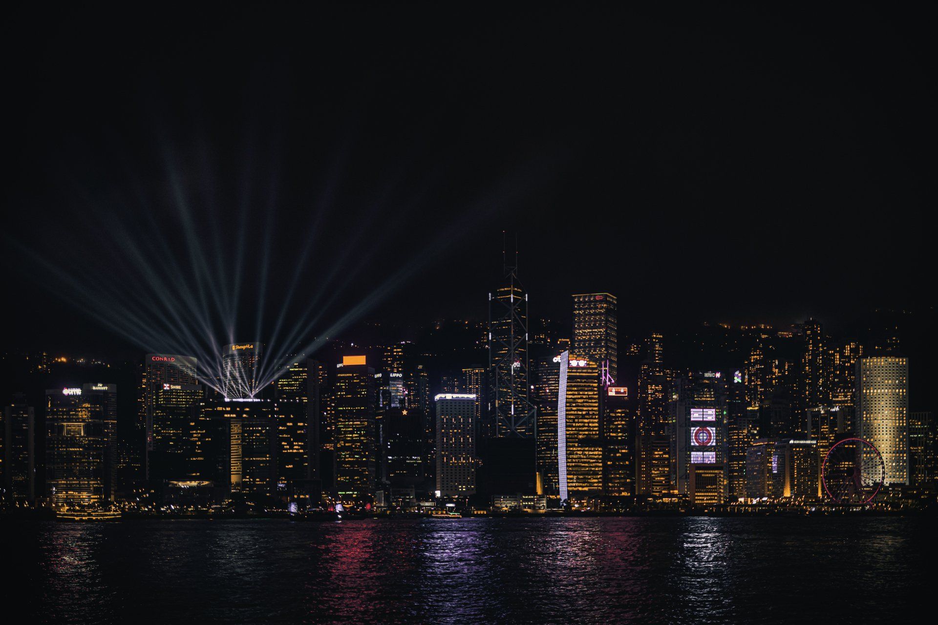 A city skyline at night with a lot of lights on the buildings