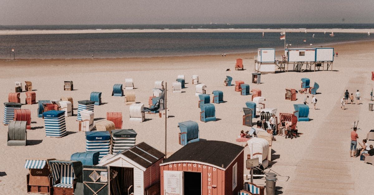 An aerial view of a beach with a lot of chairs and huts.