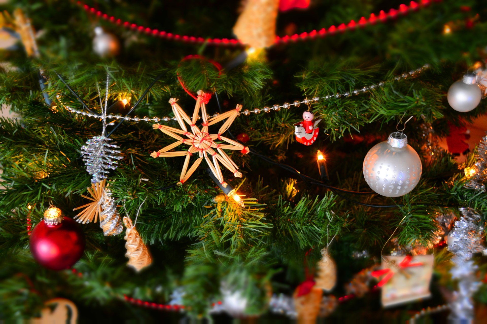 A close up of a Christmas tree with decorations and lights.