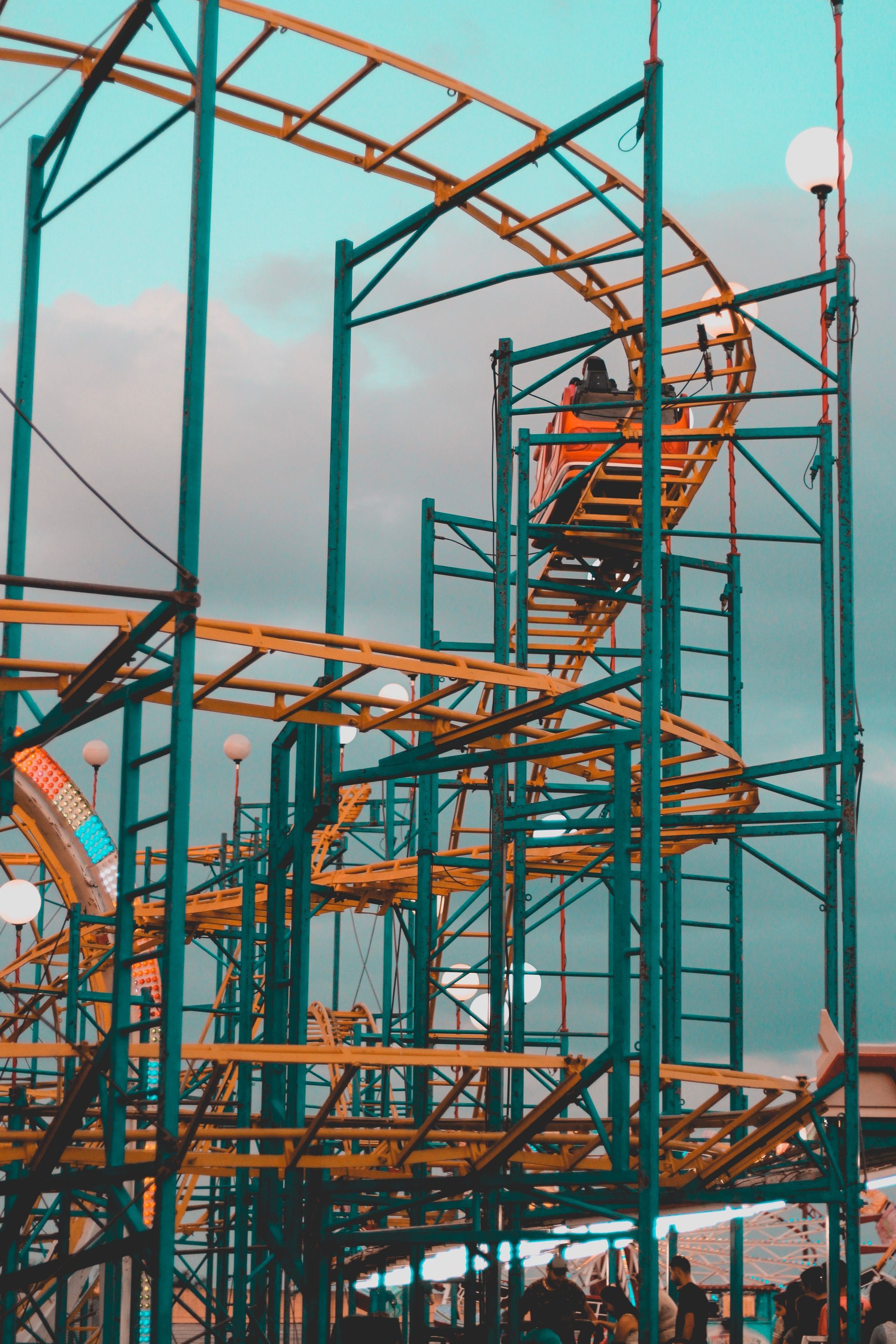 A roller coaster at an amusement park with people riding it