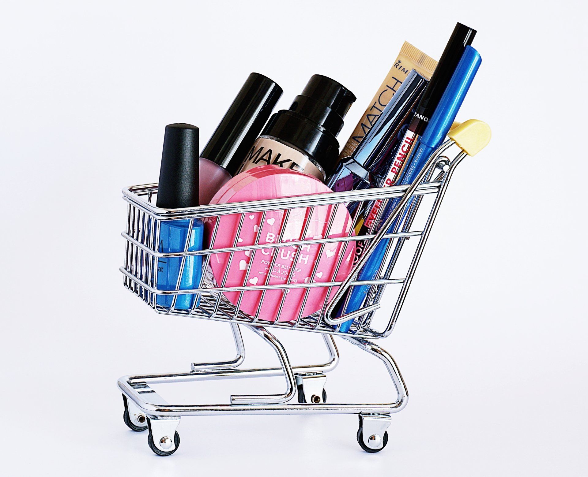 a shopping cart filled with cosmetics on a white background
