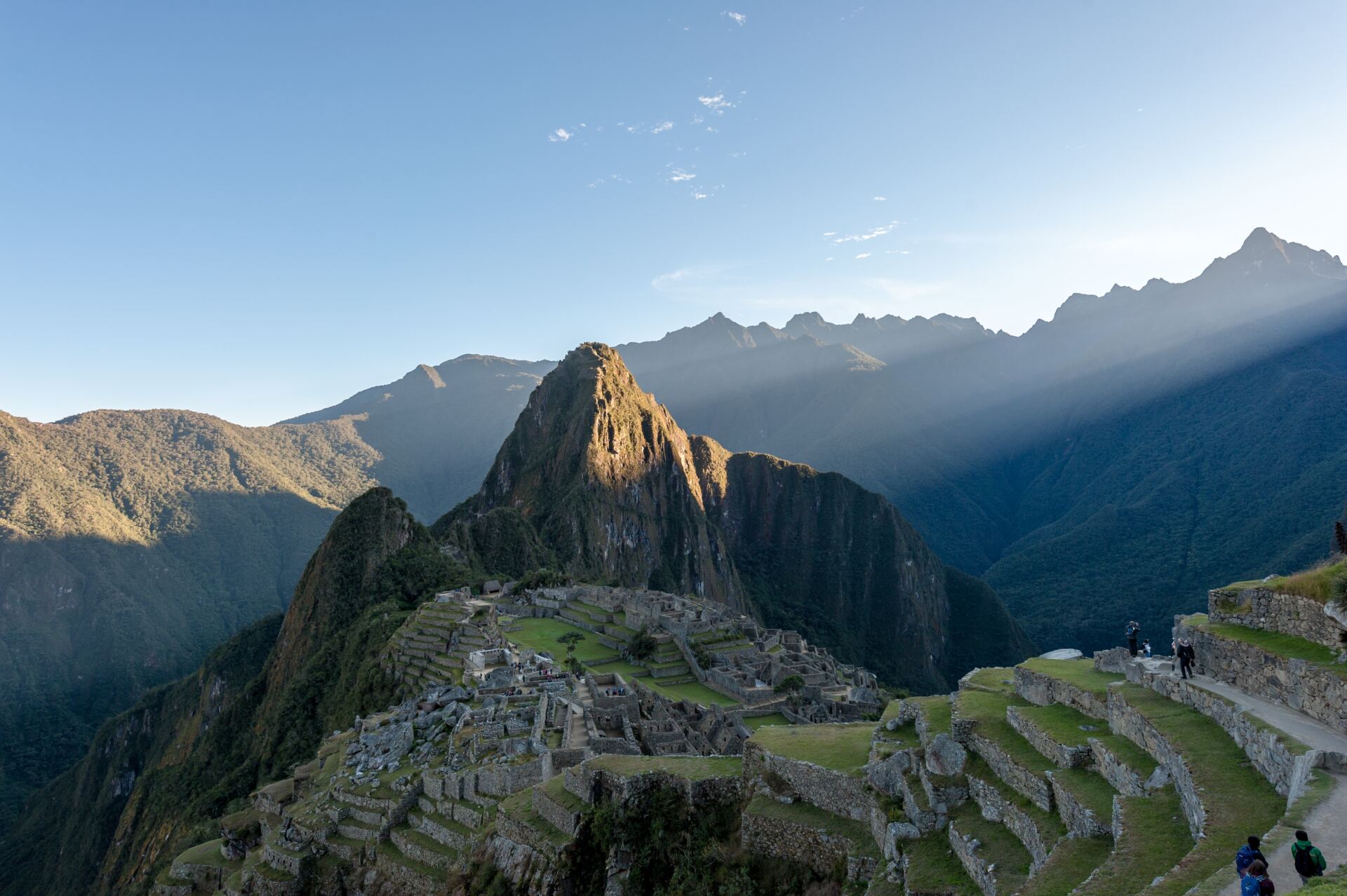 A group of people are standing on top of a mountain.