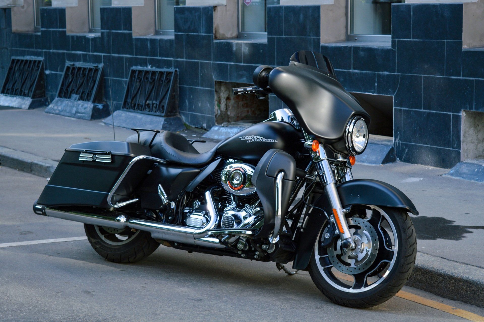 A black harley davidson motorcycle is parked on the side of the road