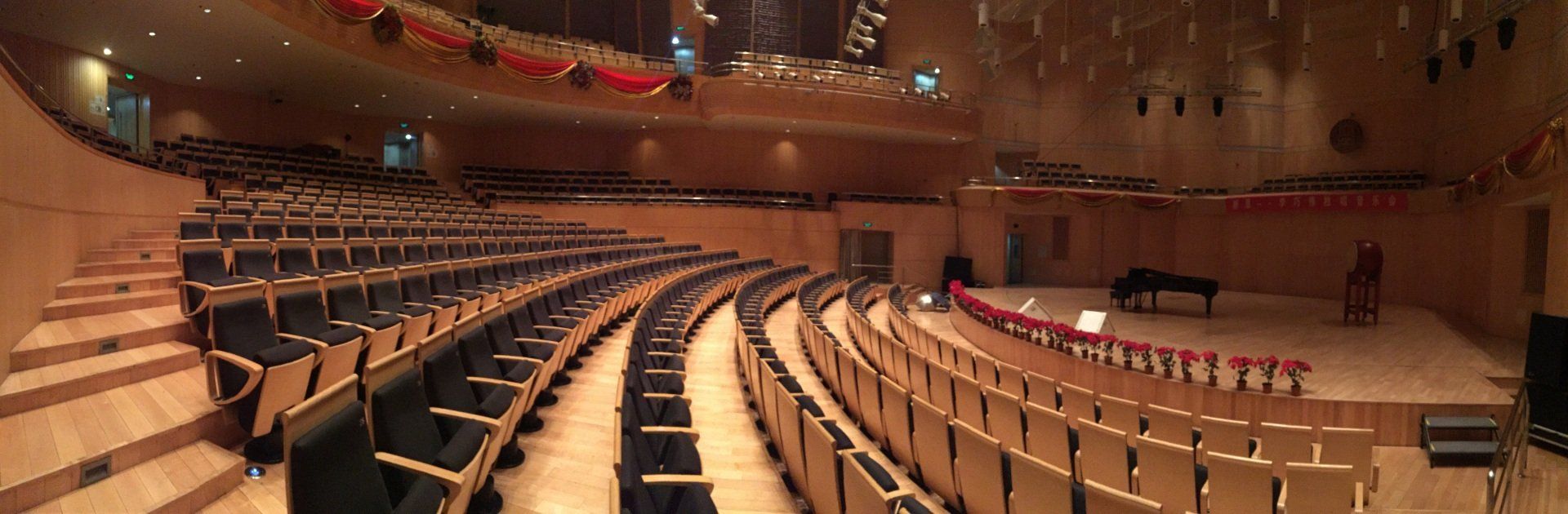 Music auditorium utilizing hardwood throughout the room to improve acoustics.