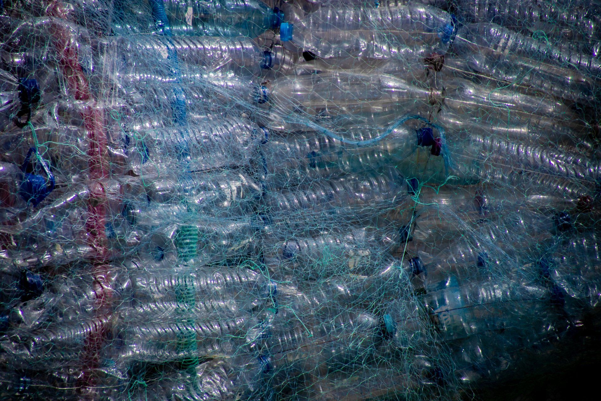 a bunch of plastic bottles are stacked on top of each other