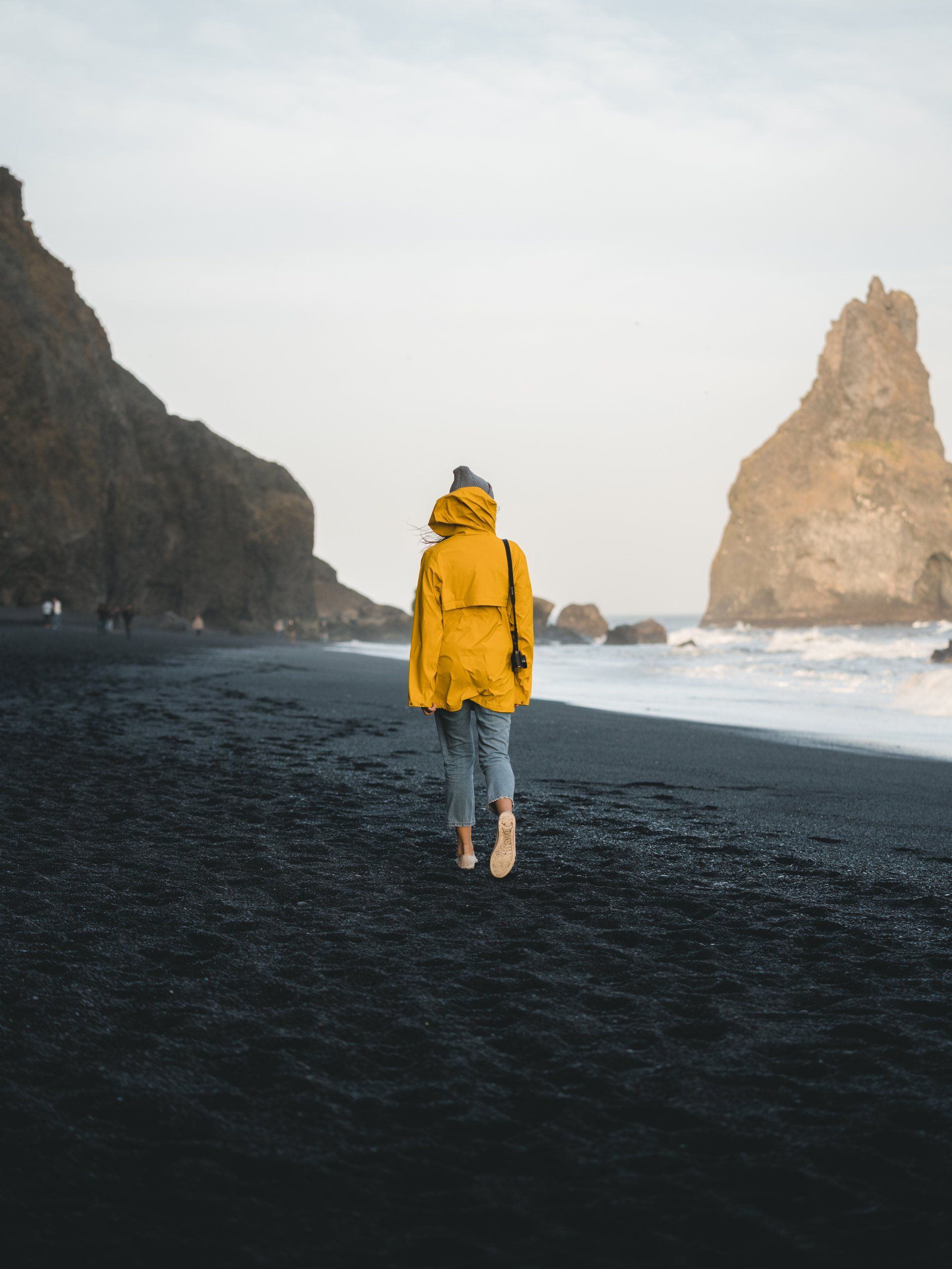 Lady walking on an empty beach 