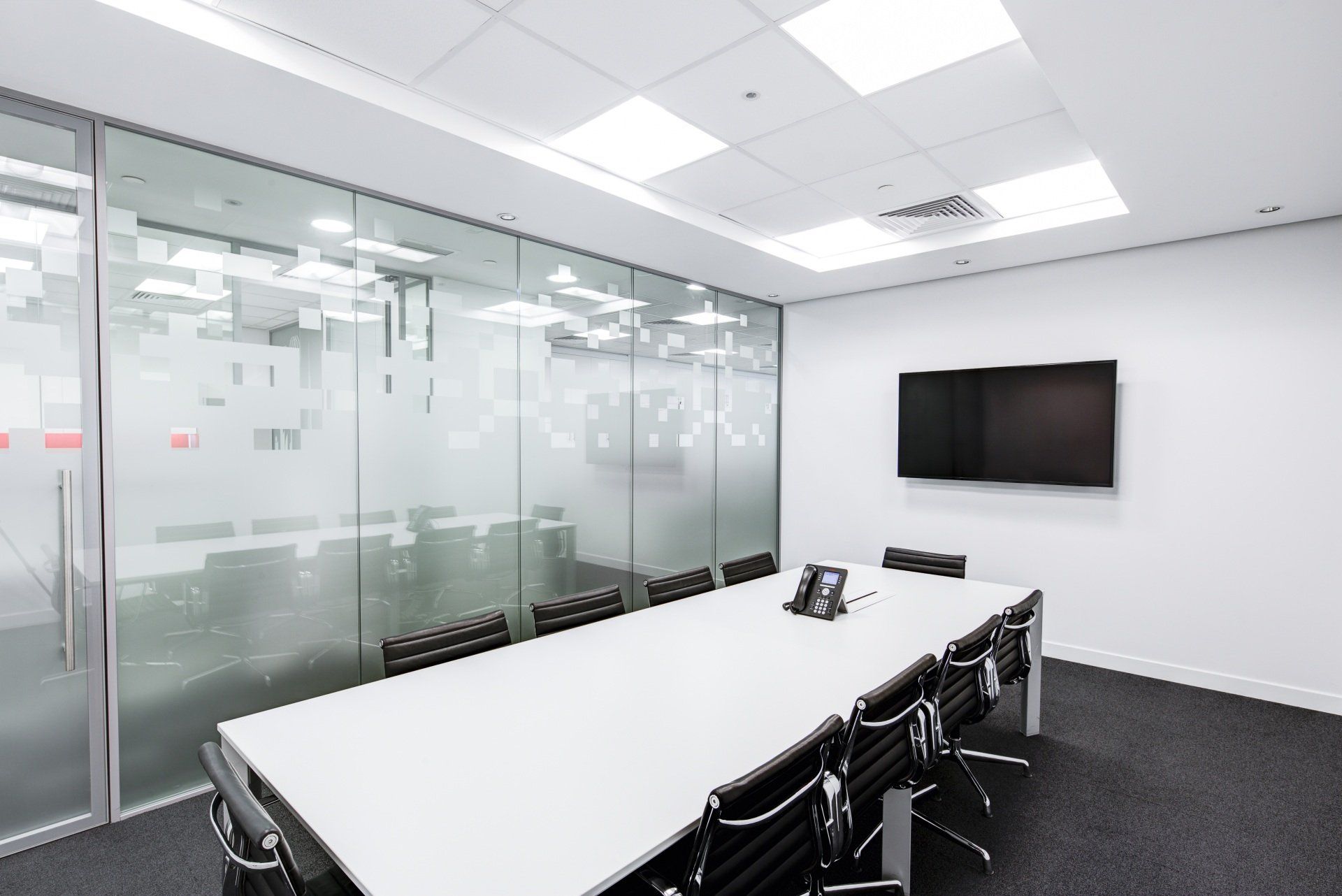 An artistic depiction of a white conference room in an office, featuring sleek minimalist design, natural lighting, and modern furnishings.