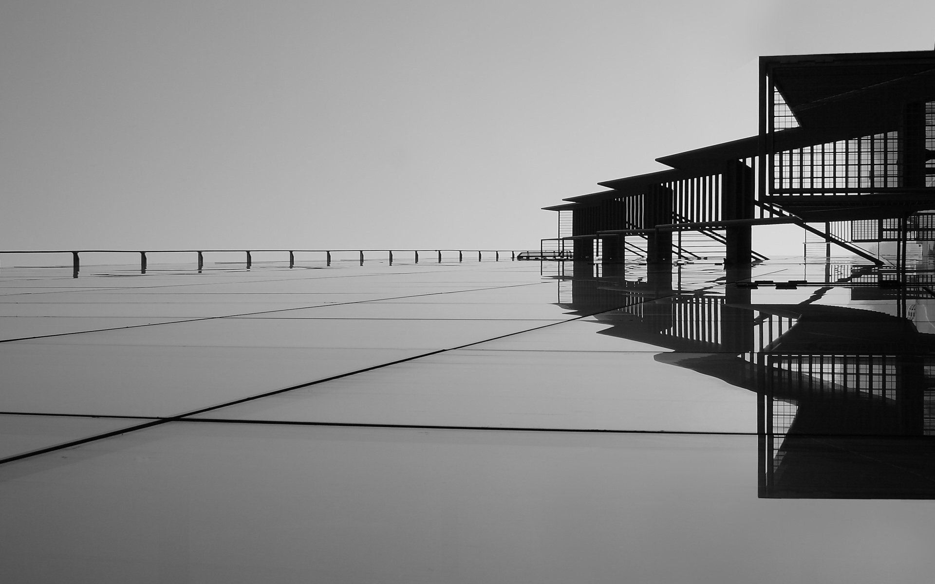 A black and white photo of a bridge over a body of water