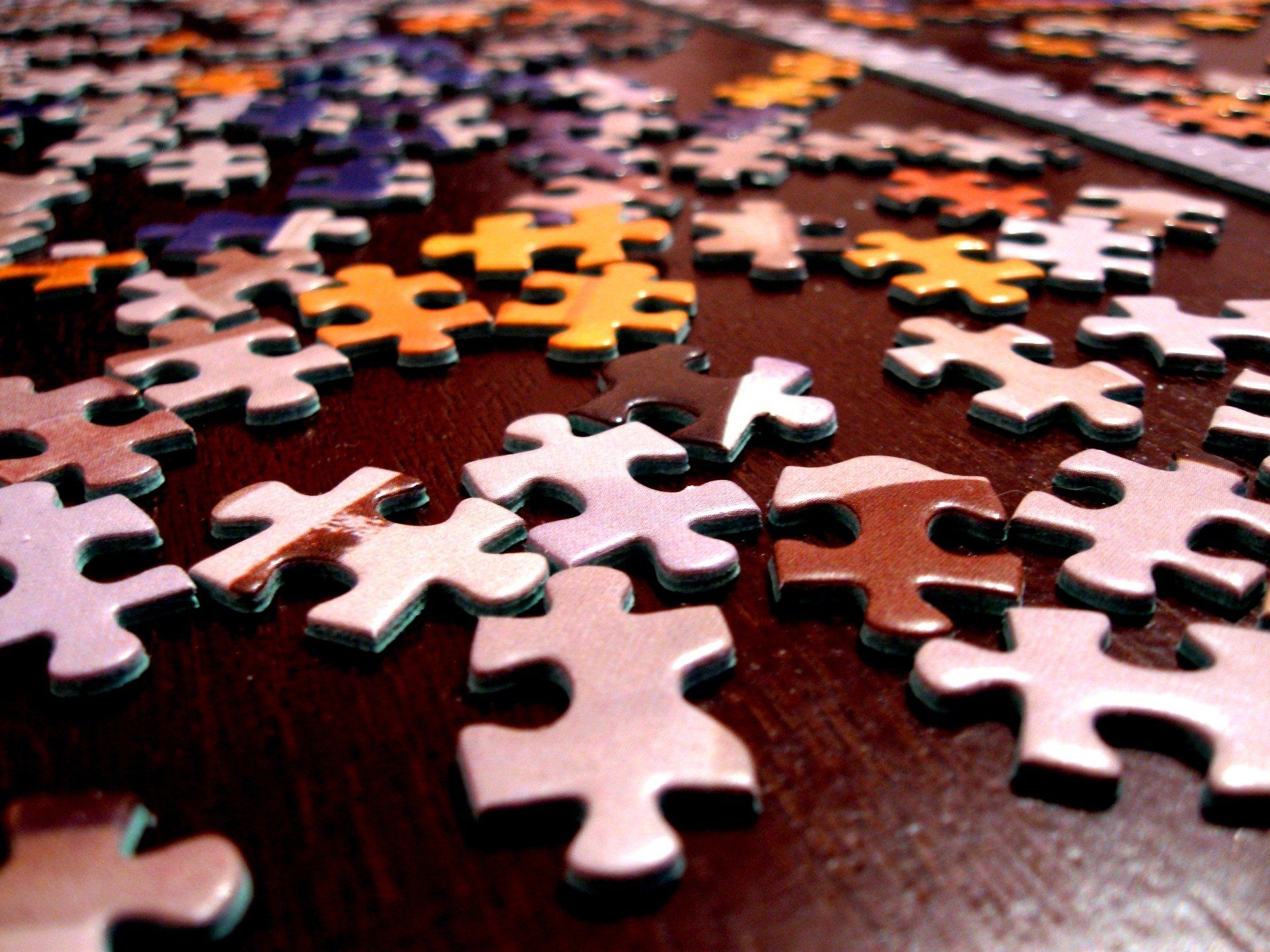 A close up of a puzzle piece on a table.