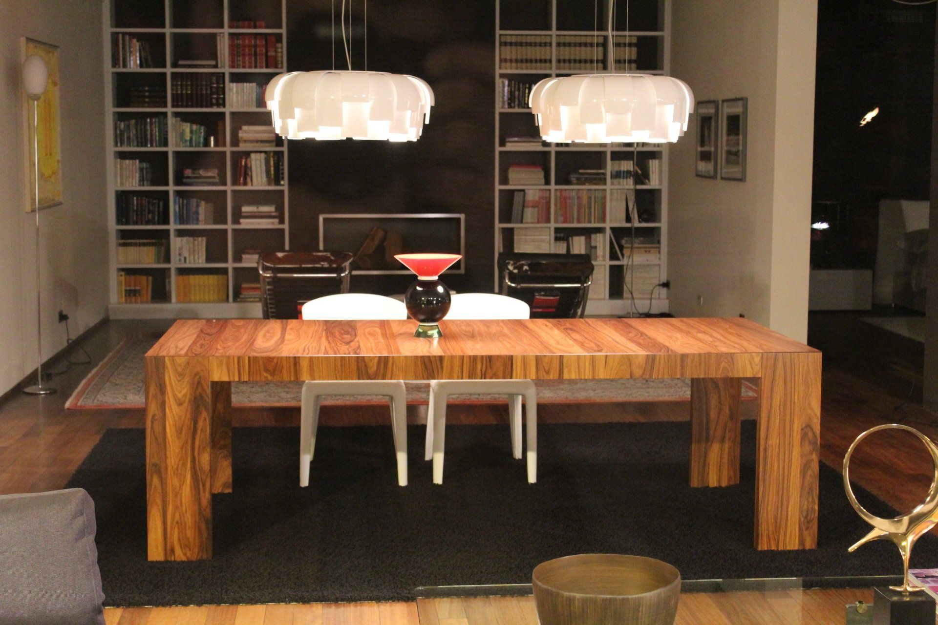 A dining room with a wooden table and chairs