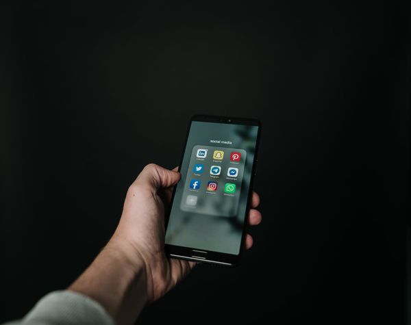 Smartphone in de hand met verschillende apps