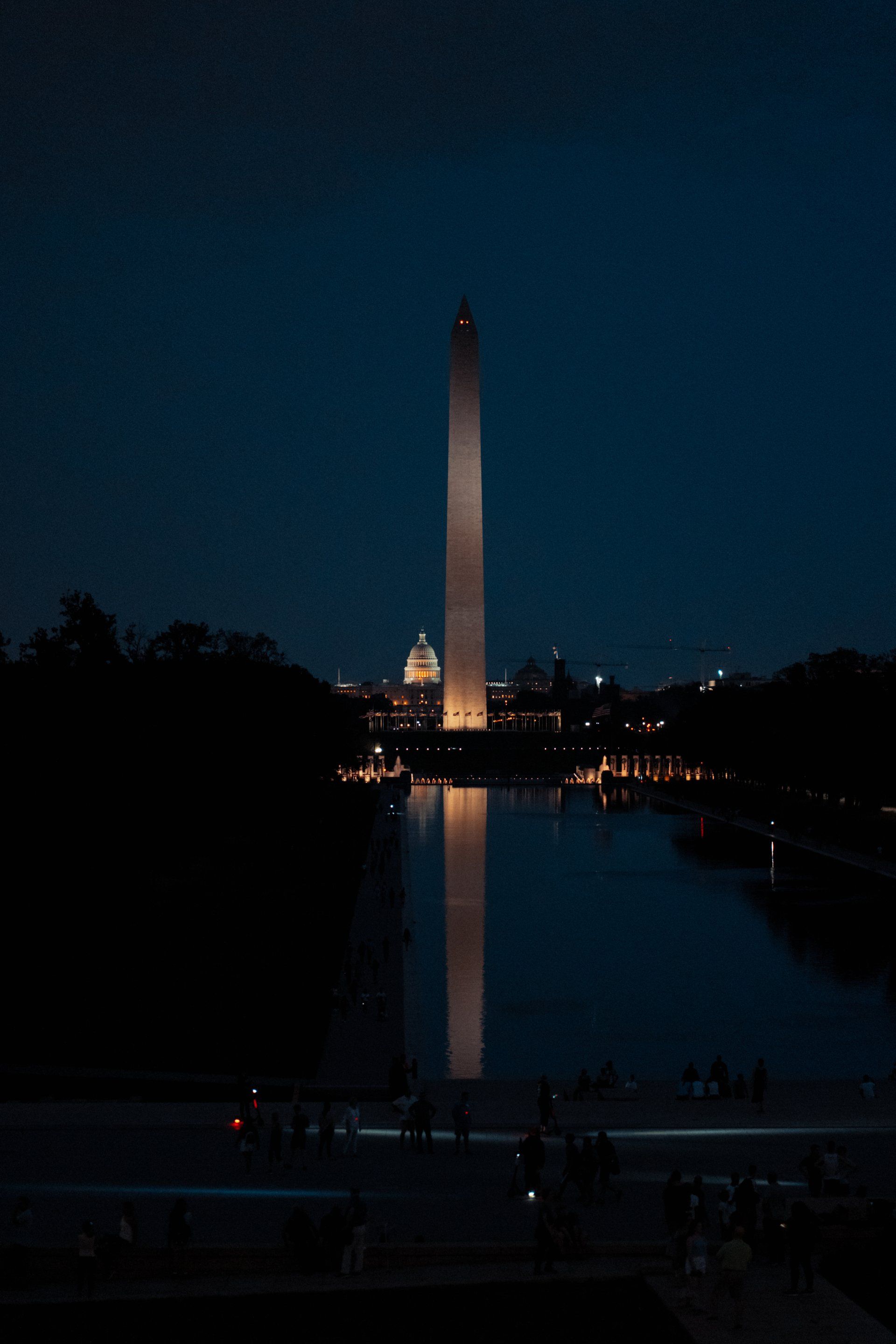 The washington monument is lit up at night in washington d.c.