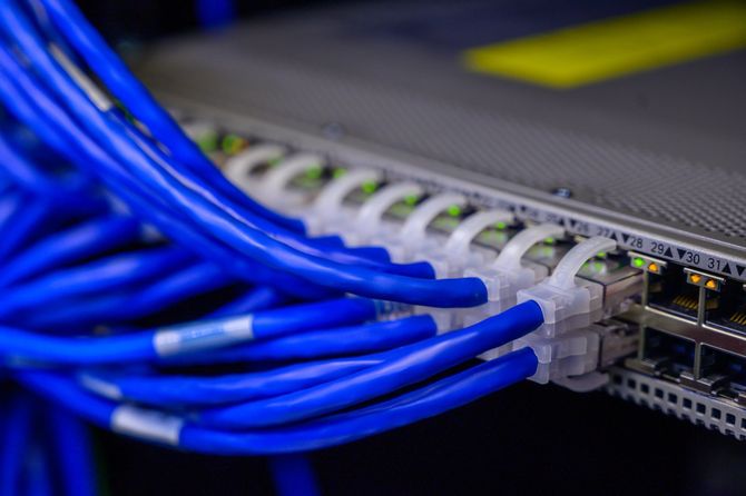 A bunch of blue wires are connected to a server.