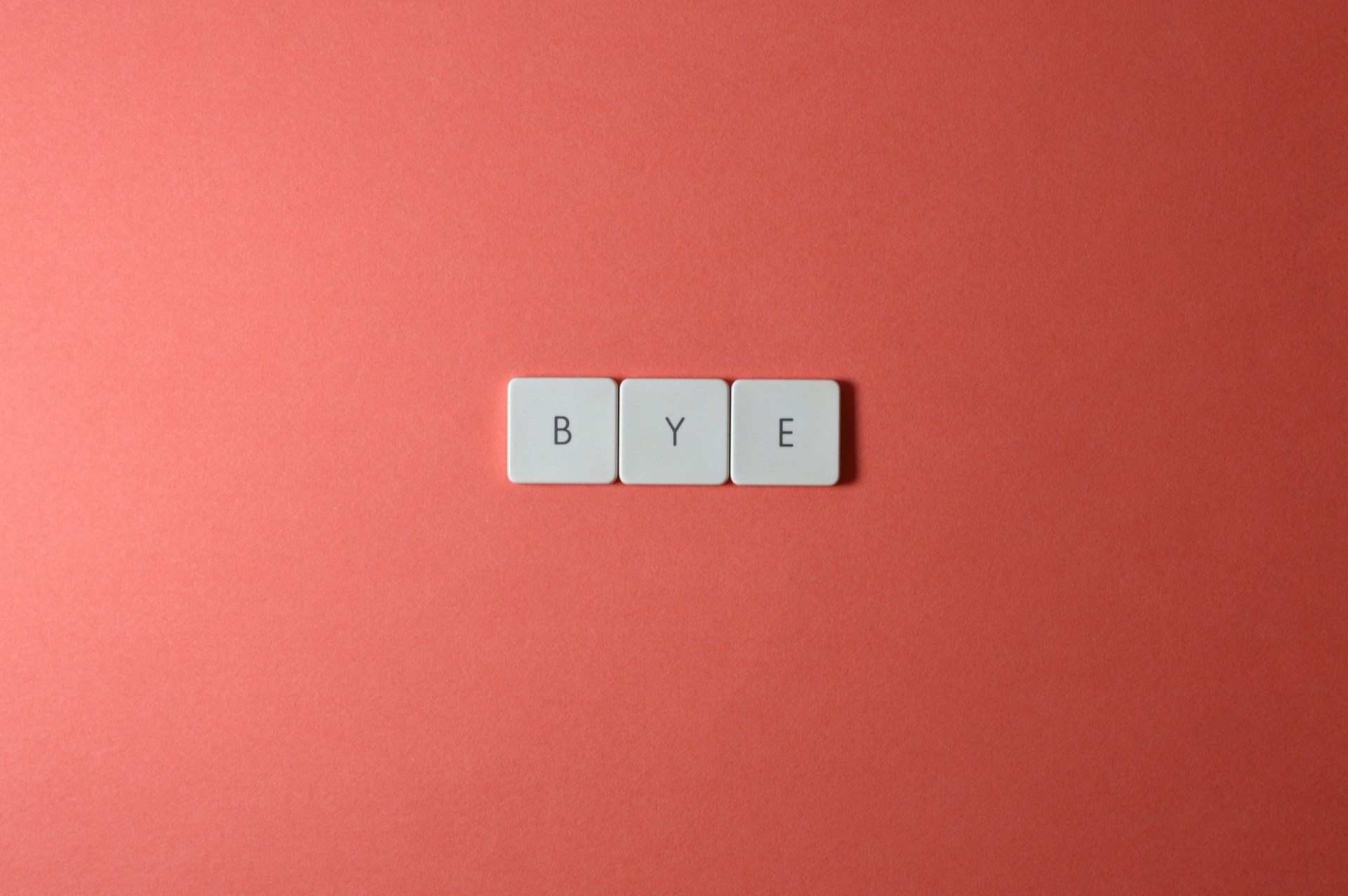 the word bye is written in white tiles on a red background .
