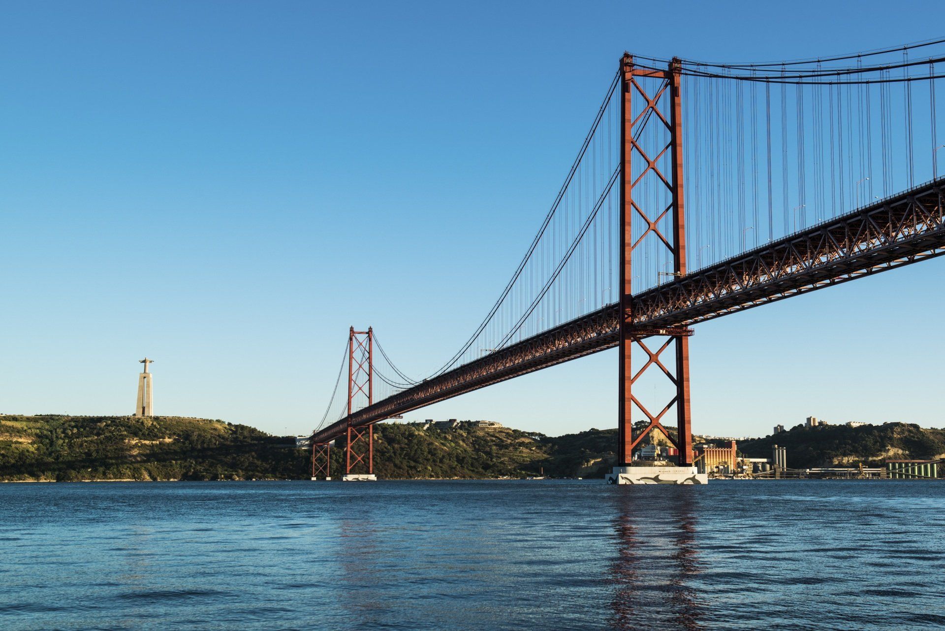 A bridge over a body of water with a blue sky in the background