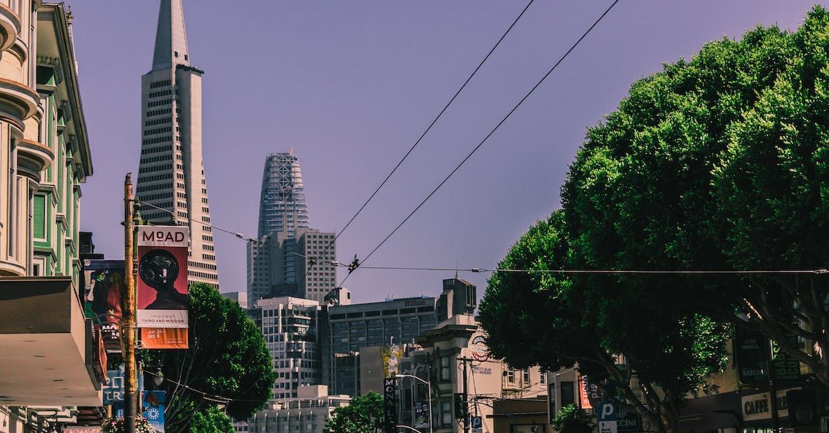 A city street with a large building in the background