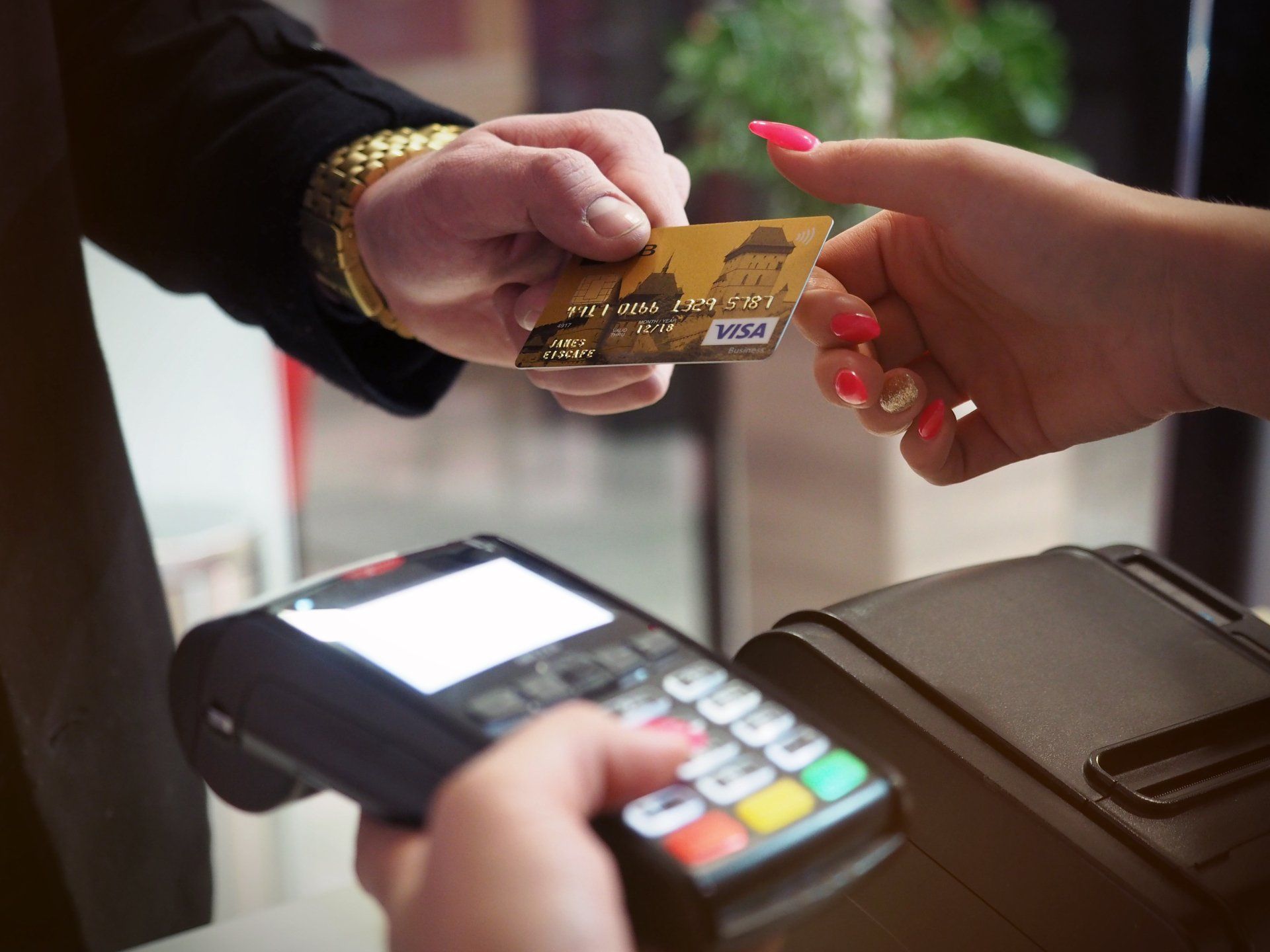 Customer handing their credit card to a merchant
