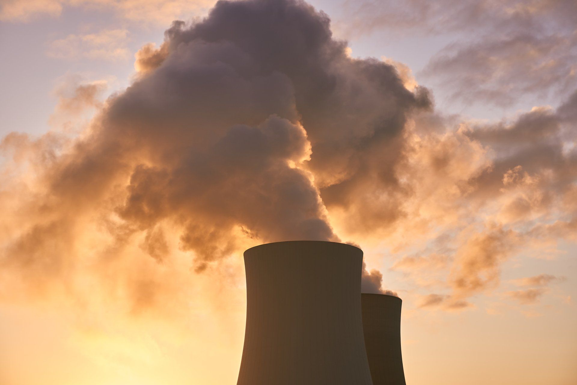 Carbon Emissions coming out of the cooling towers during sunset.