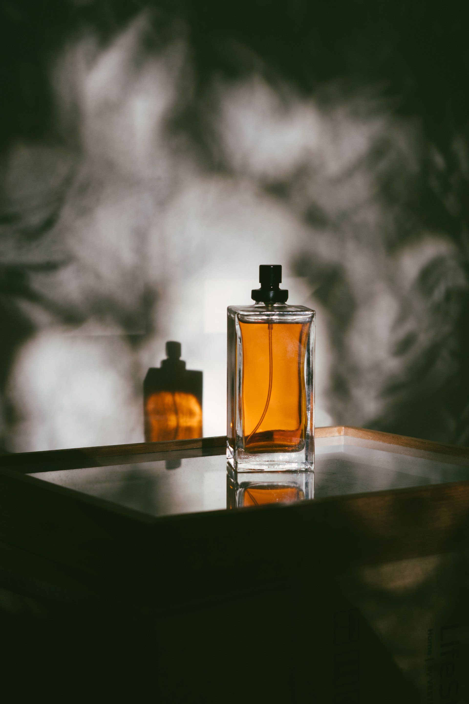 A bottle of perfume is sitting on a table.
