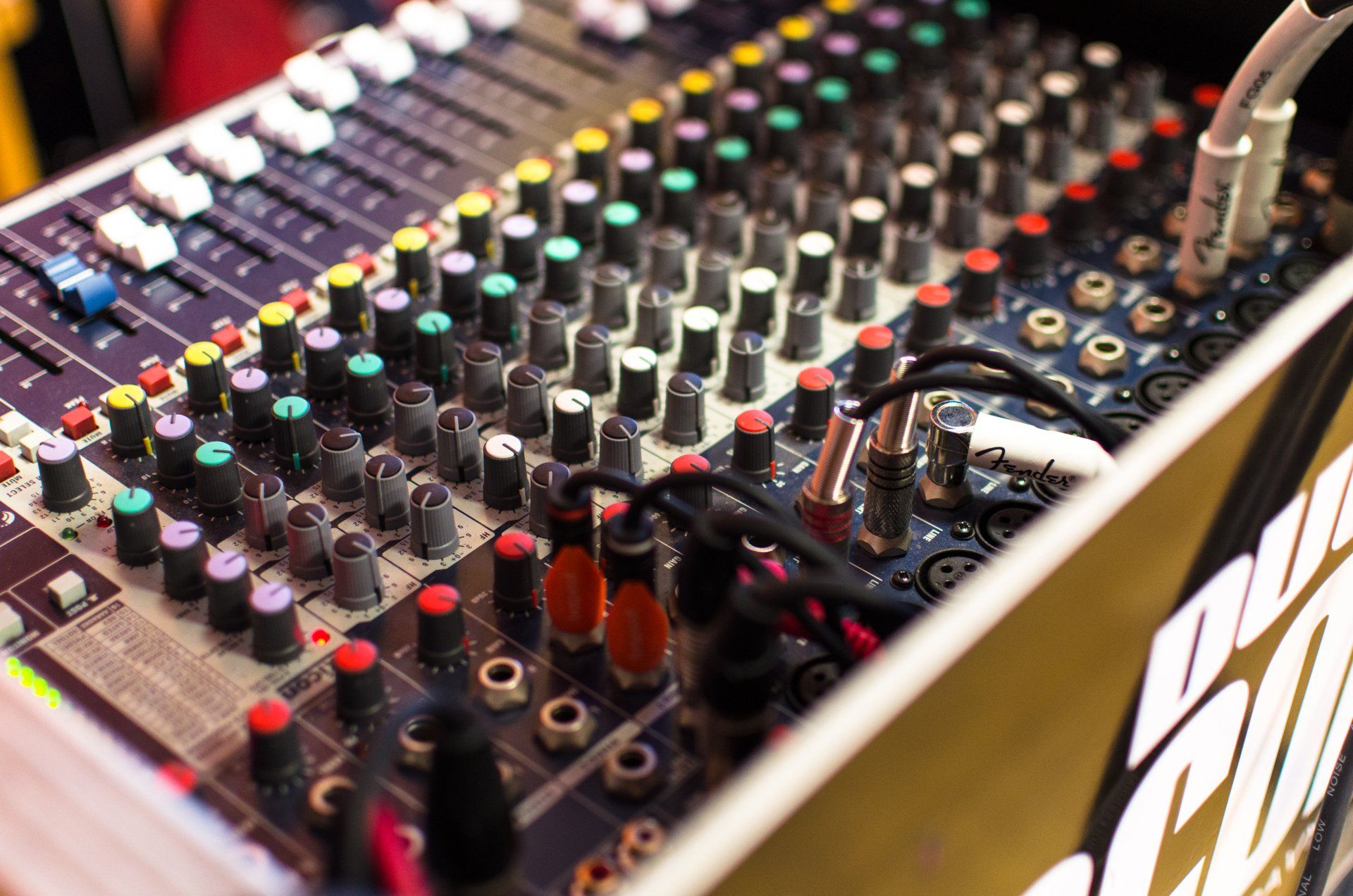A mixer with a lot of knobs and buttons on it