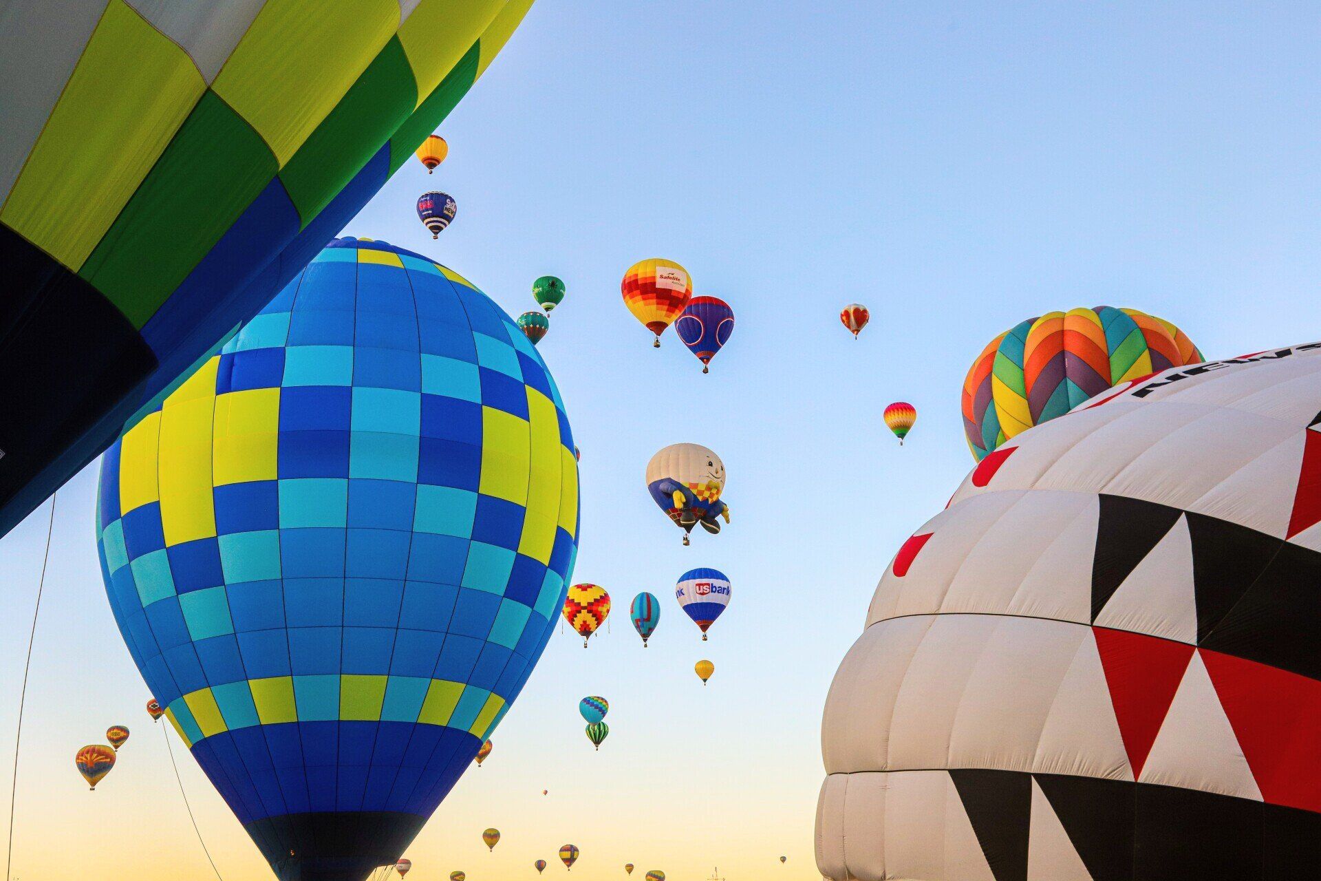 A bunch of hot air balloons are flying in the sky