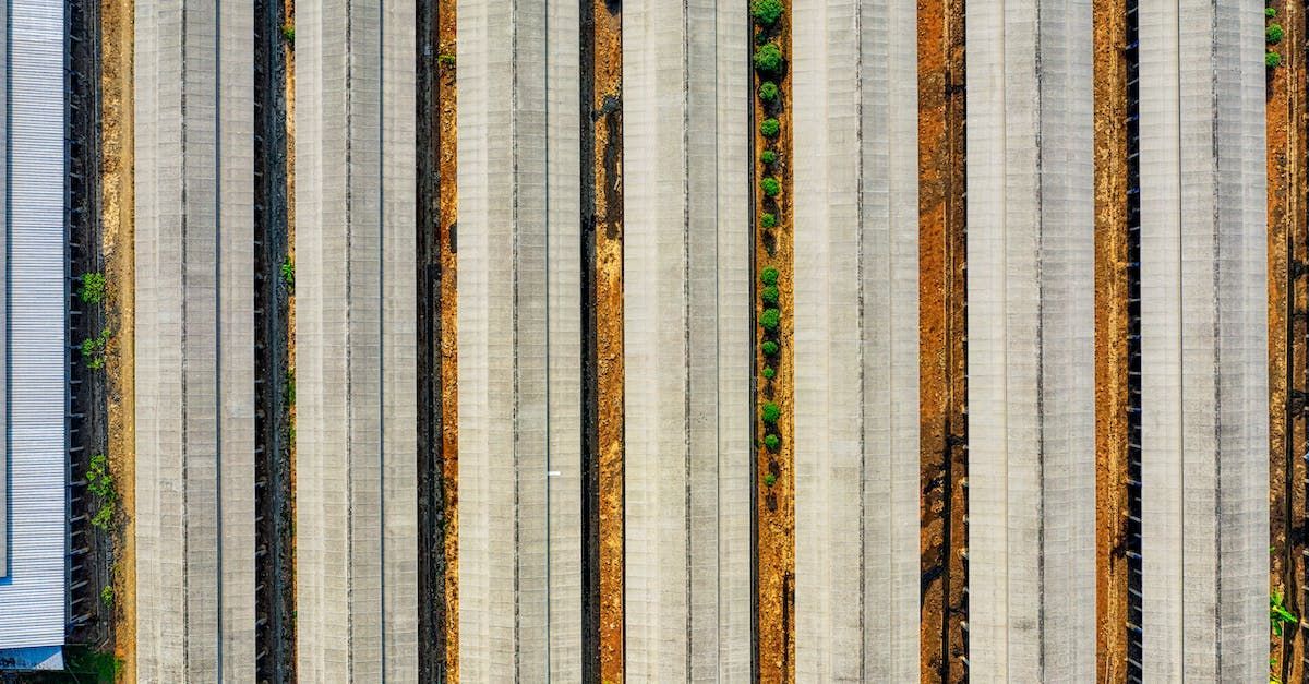 An aerial view of a row of concrete columns in a field.