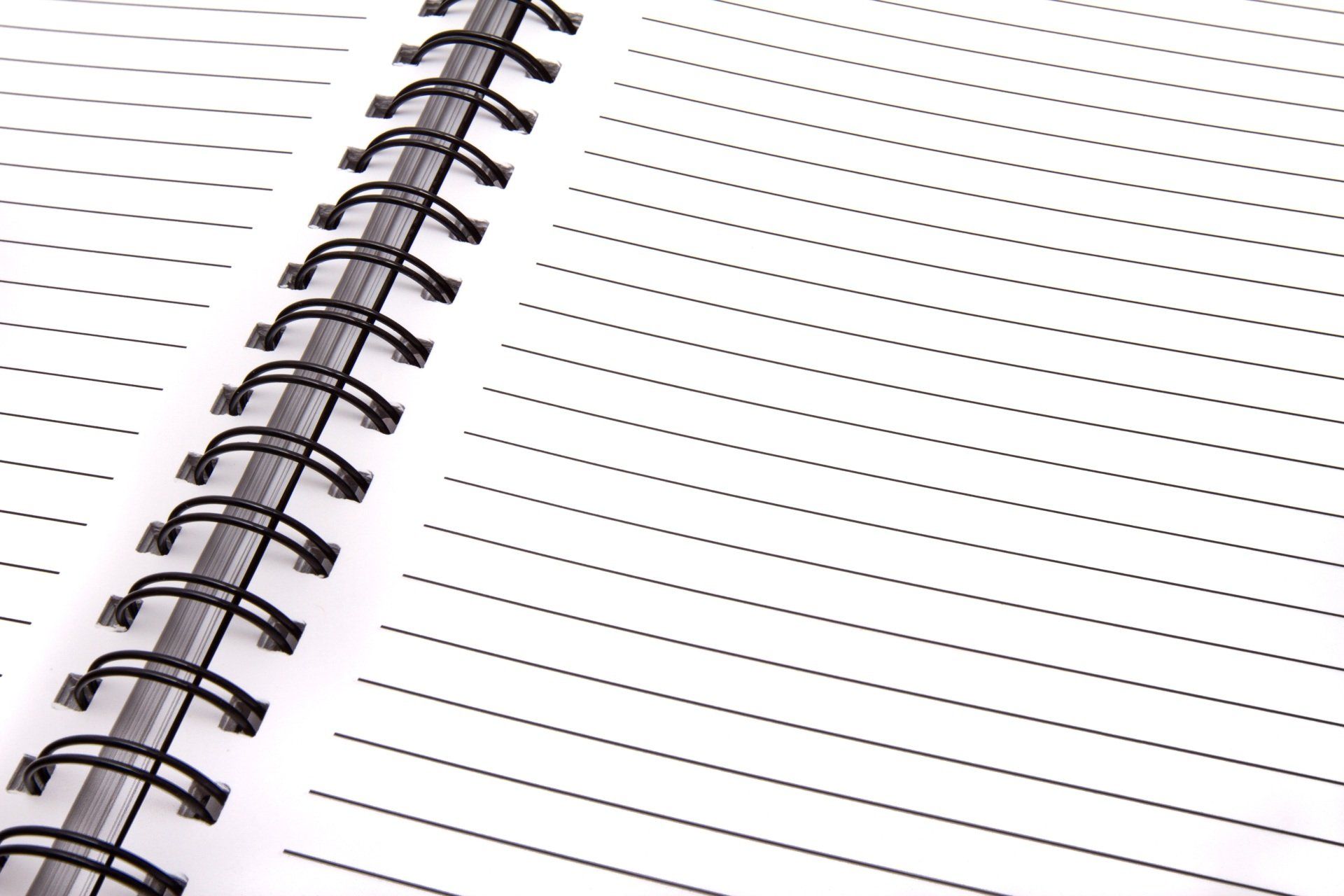 a close up of a spiral notebook with dots on the pages .