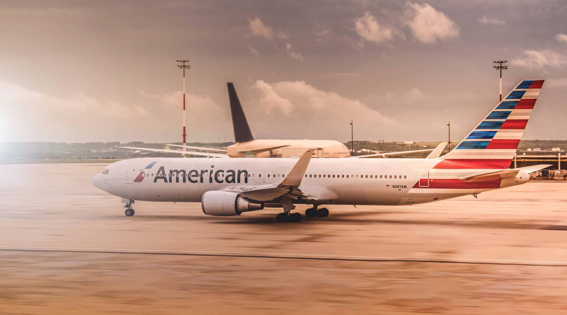 an american airlines plane is parked on the tarmac at an airport.