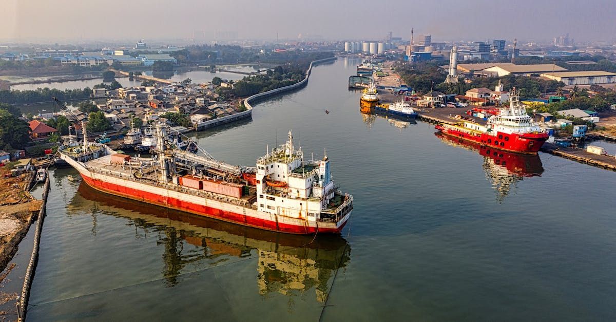 An aerial view of a large ship in the middle of a river.