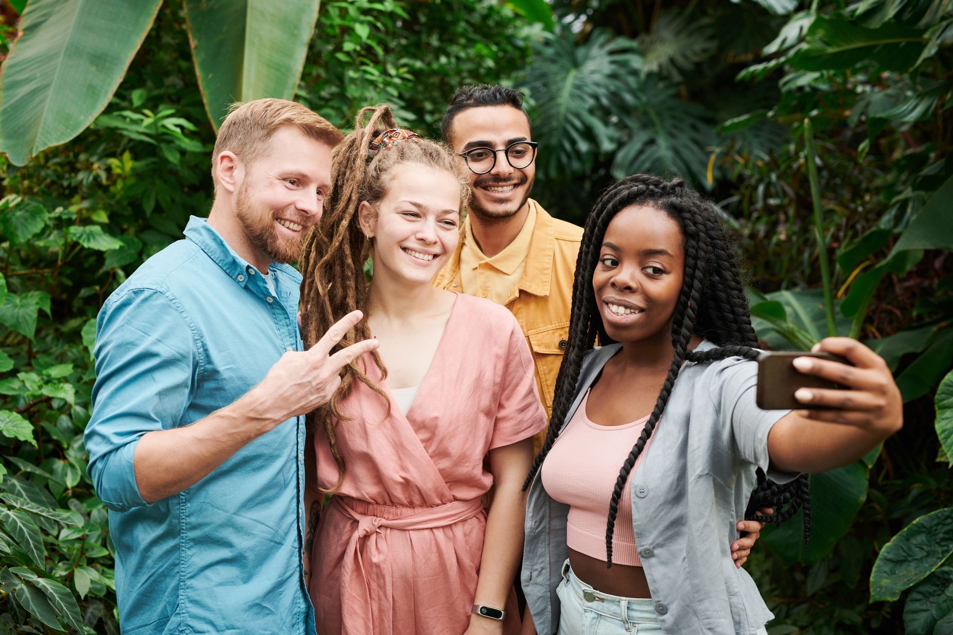 A group of people are taking a selfie in the jungle.