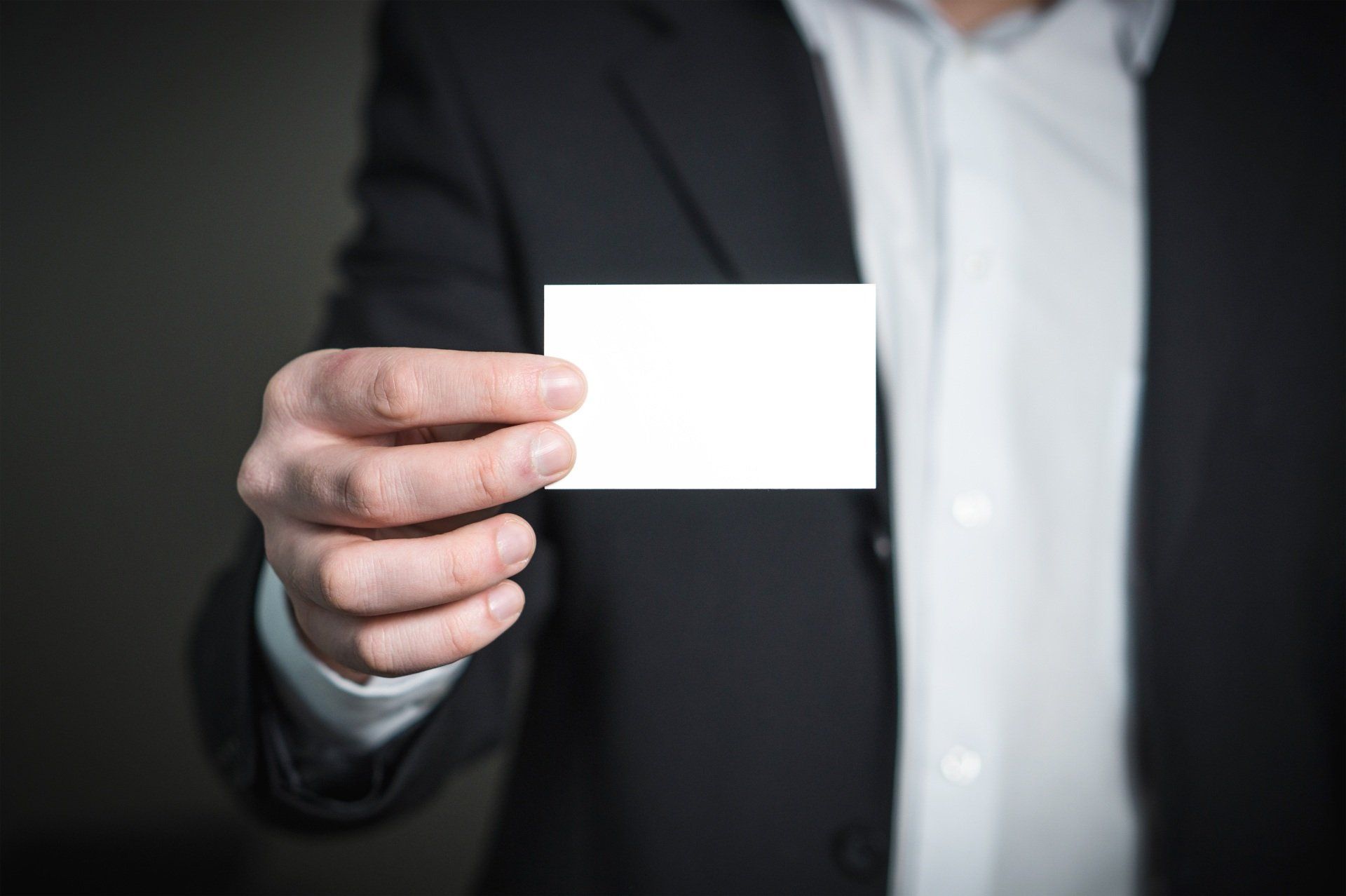 a person handing a business card