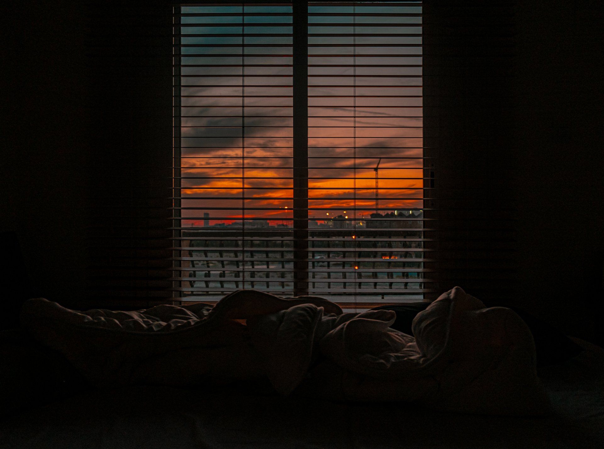 view of sunrise through window in dark room