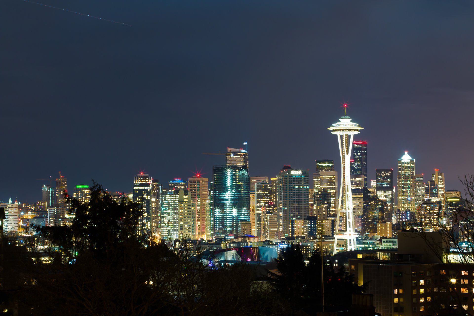 Seattle Skyline view of Space Needle and downtown building lit up at night 