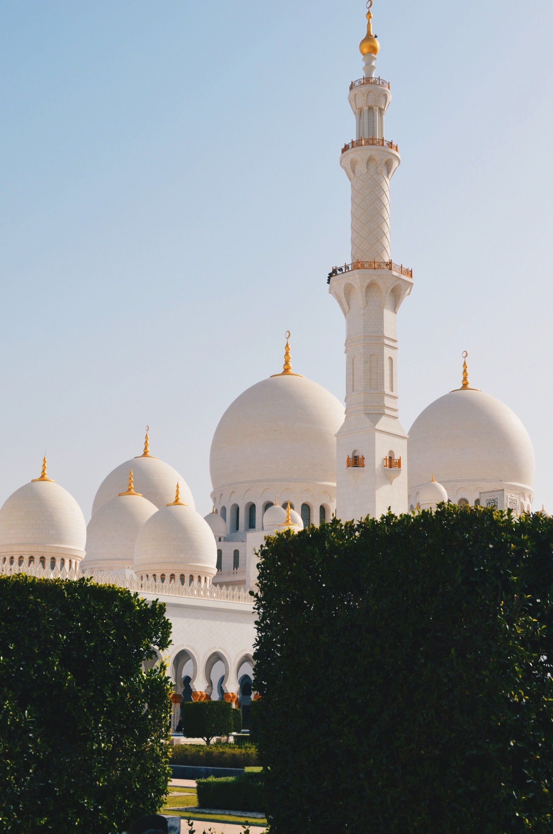 A large white mosque with a very tall minaret