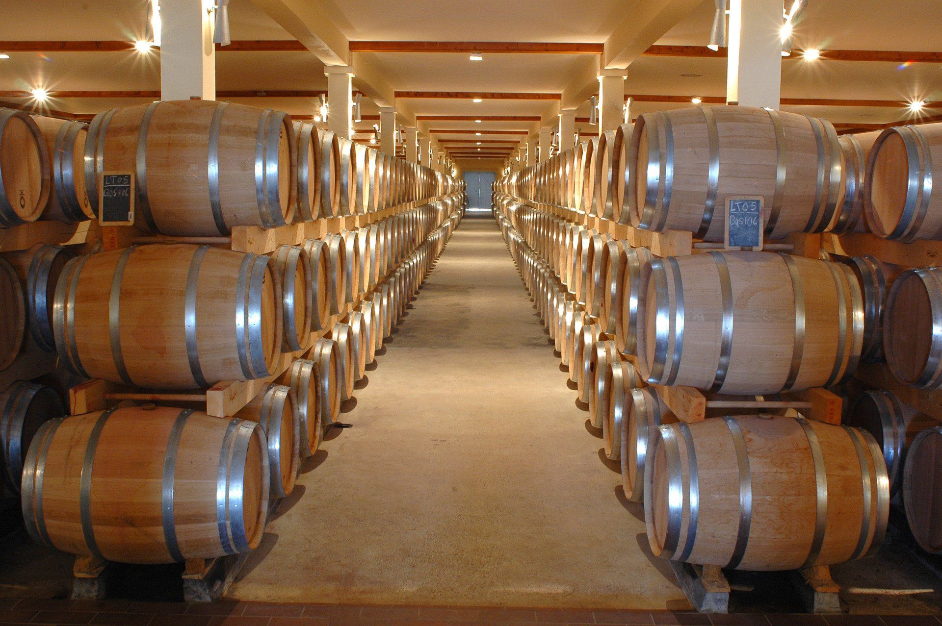 A warehouse filled with lots of wooden barrels