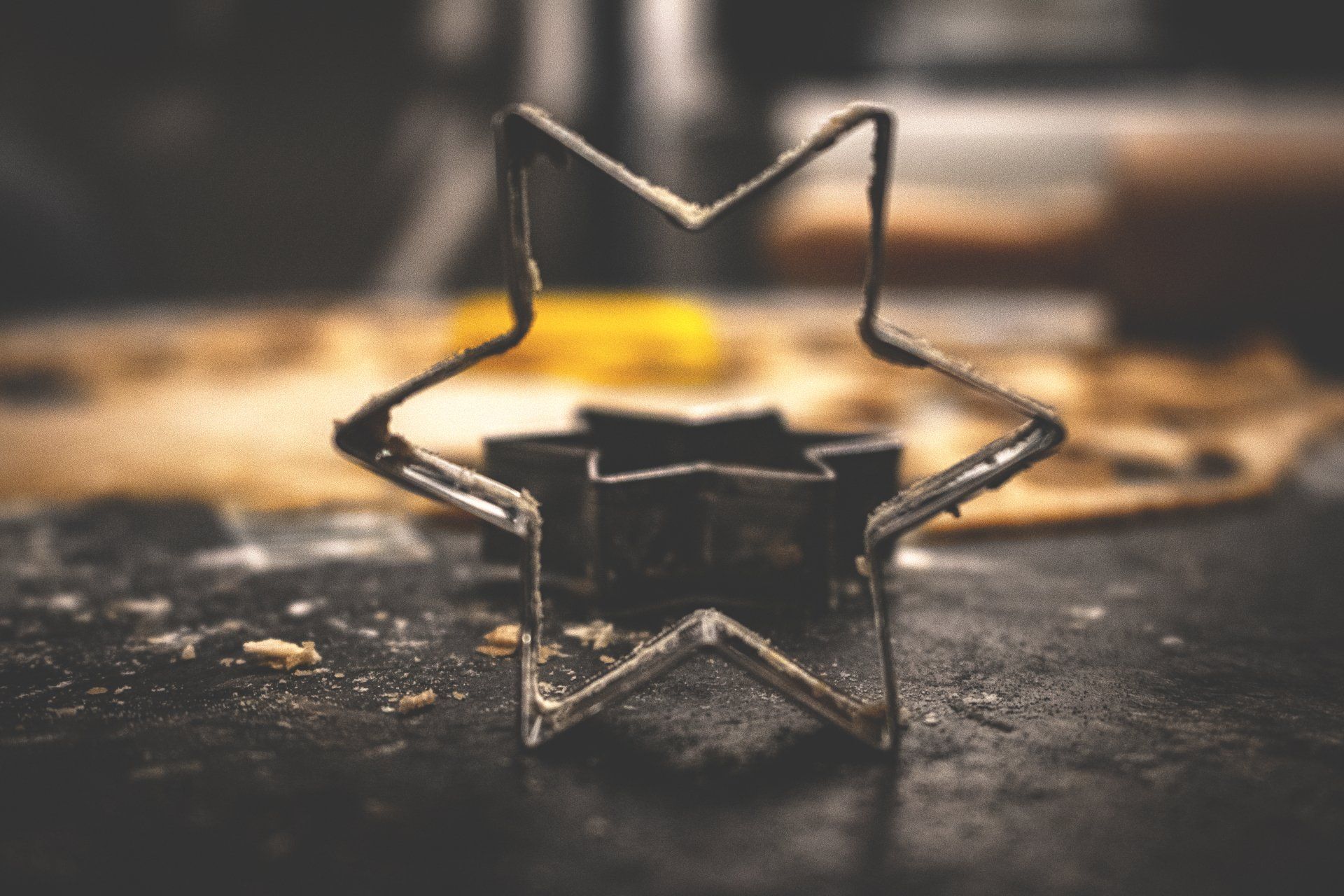 A star shaped cookie cutter is sitting on a table.