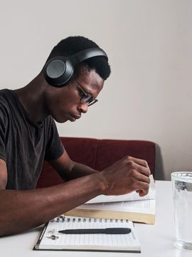 a student athlete wearing headphones studying at prep school 