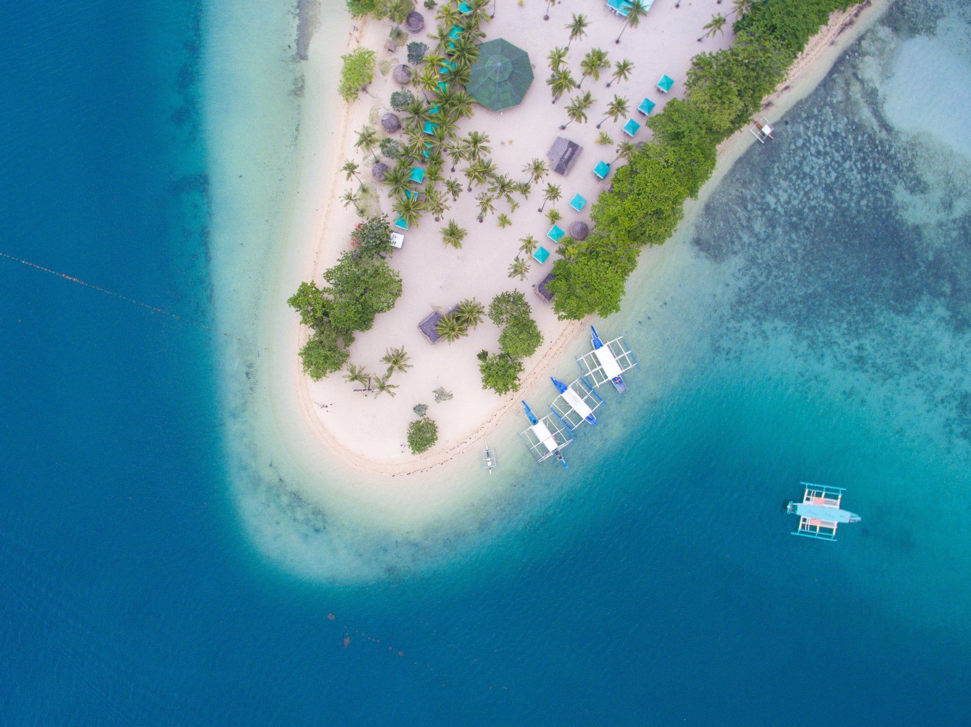 An aerial view of a small island in the middle of the ocean.