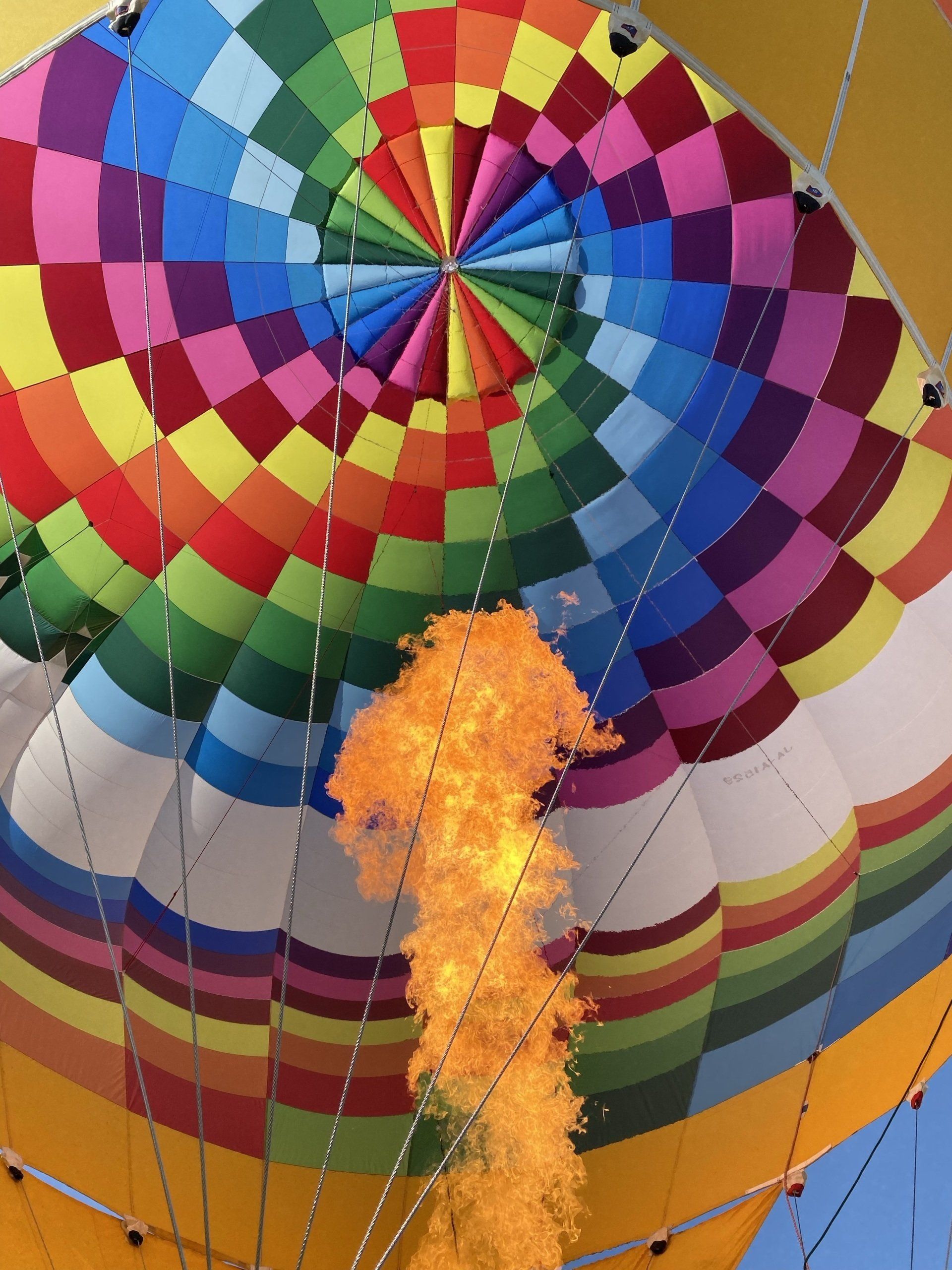 A colorful hot air balloon with flames coming out of it