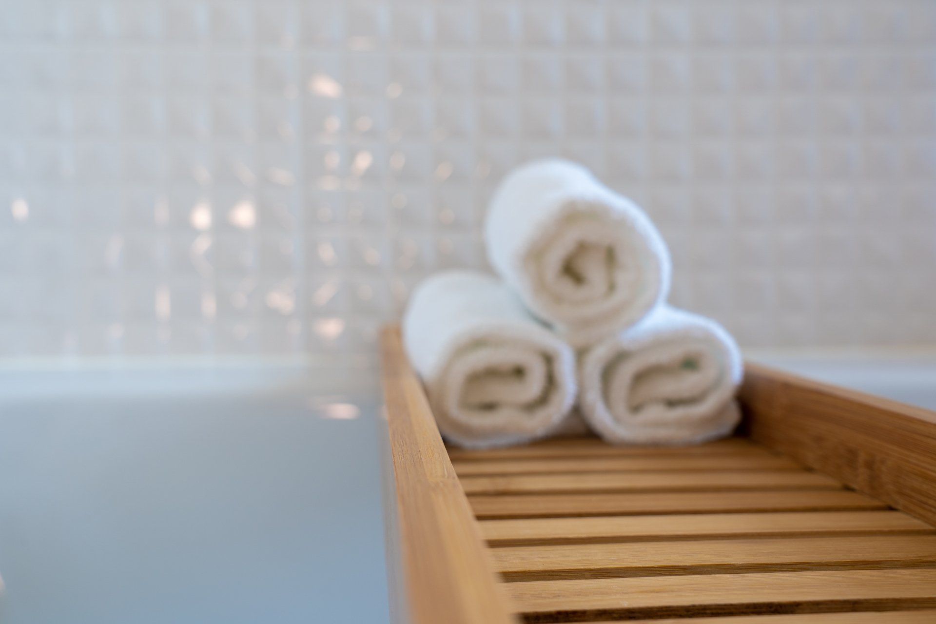 a bath tub with three towels