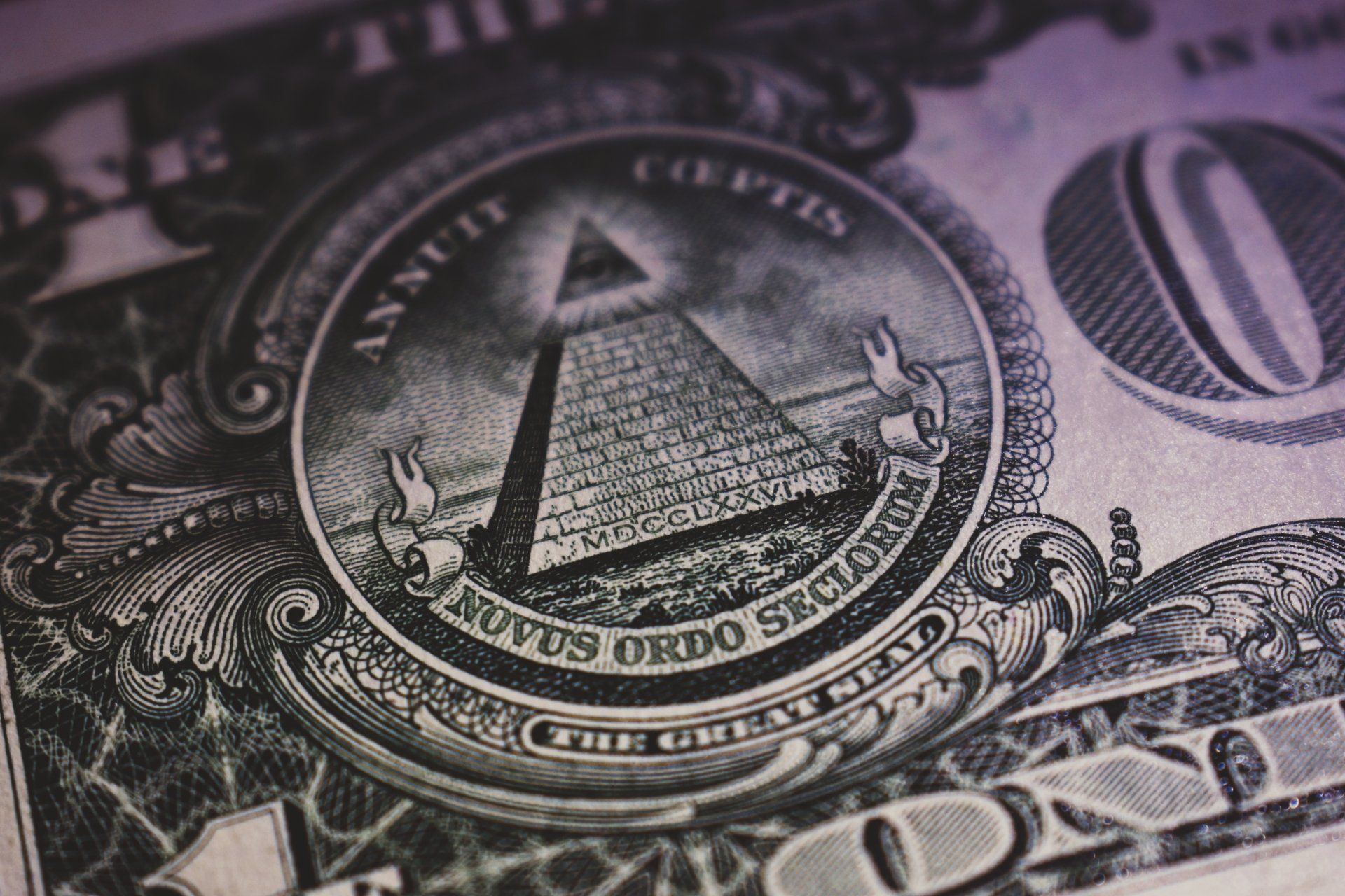 A close up of a dollar bill with a pyramid on it