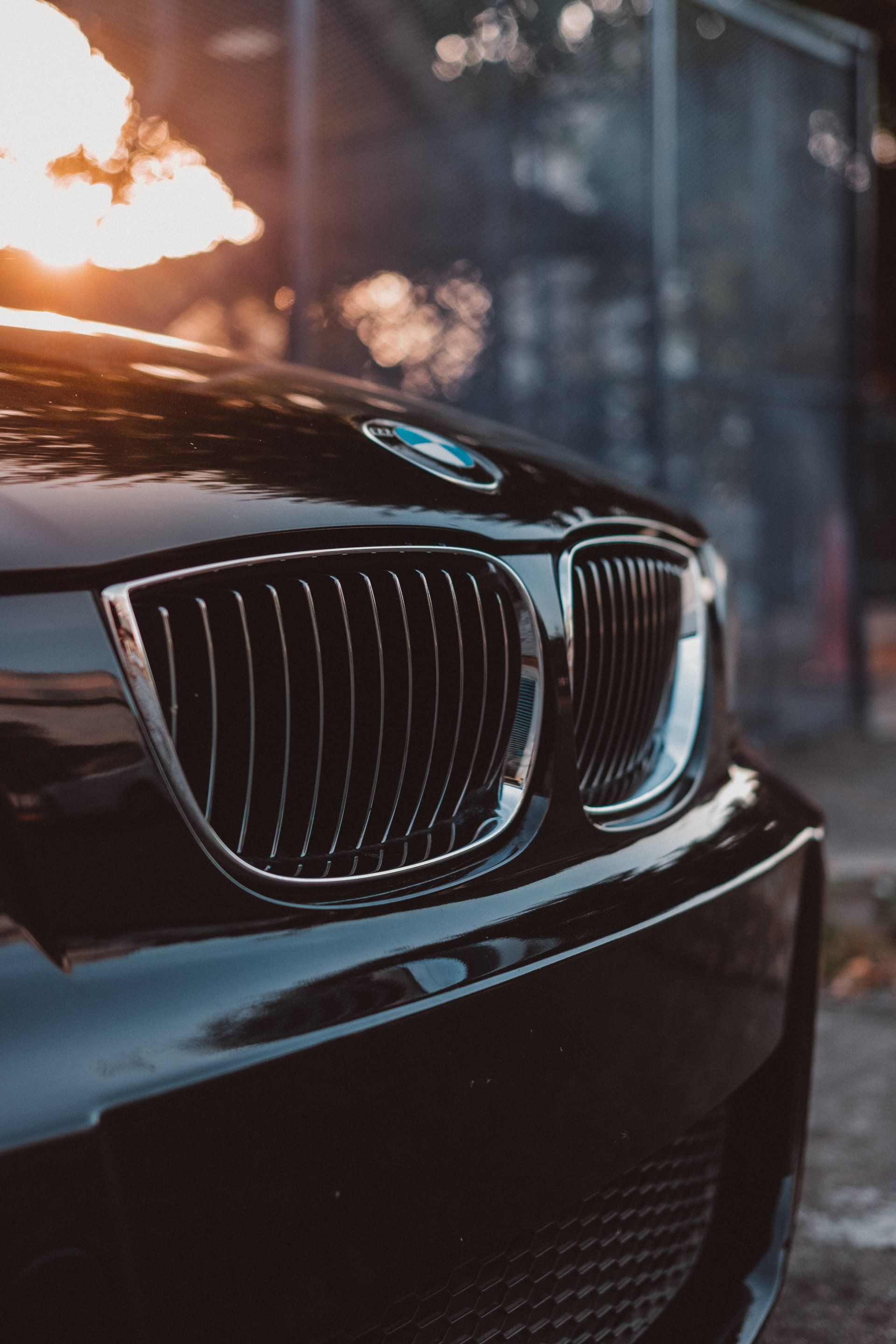 A close up of the front of a black bmw car.