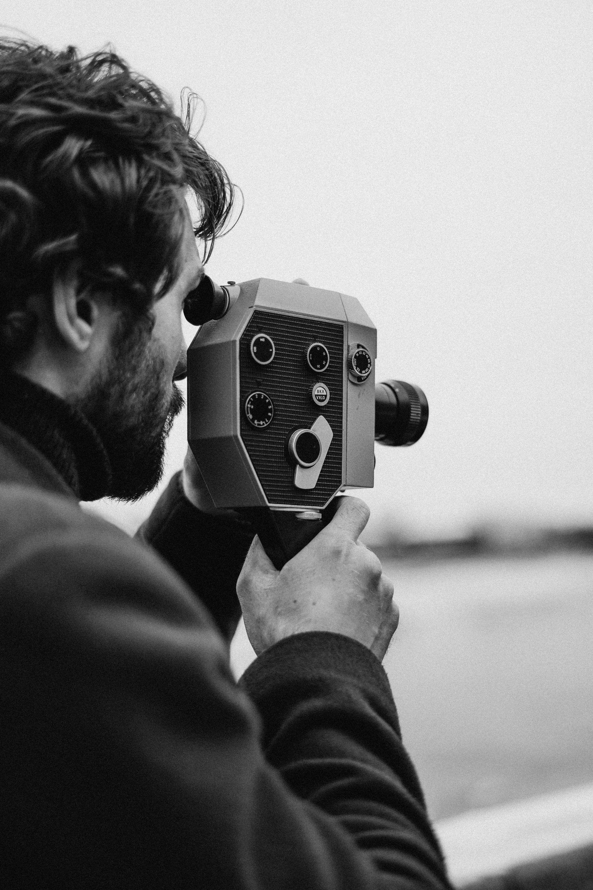 man adjusting aperture of old vintage style camera